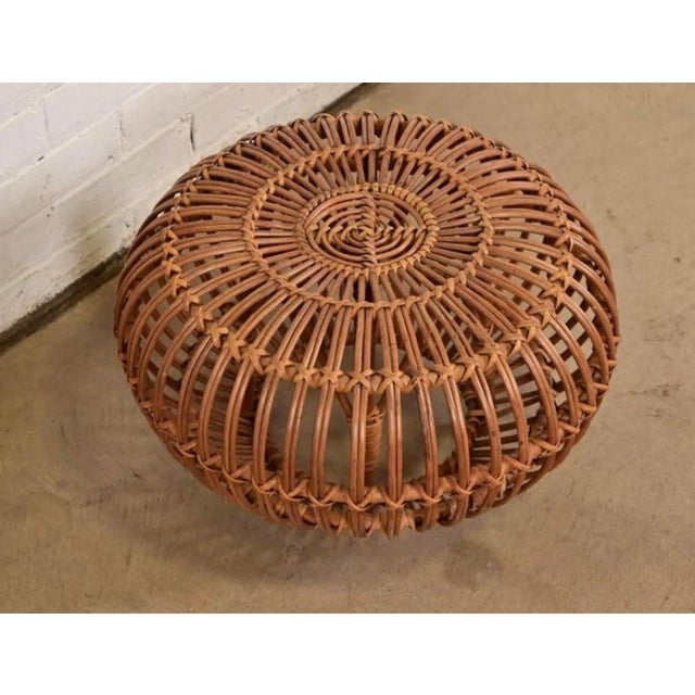 An Italian 1960's hand woven rattan ottoman attributed to Franco Albini. The versatile ottoman can be used as a footstool,...