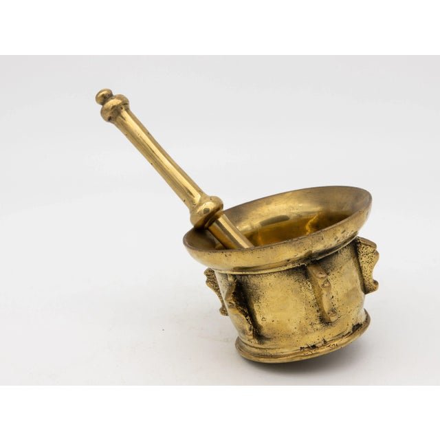This early 20th-century mortar and pestle is made of brass with an honest patina. Both the mortar and pestle are...