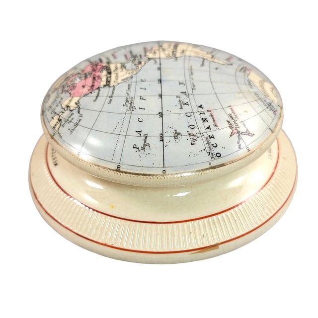 A late 19th-century refined earthenware paperweight by james macintyre & co., dating to circa 1889 and decorated with a...