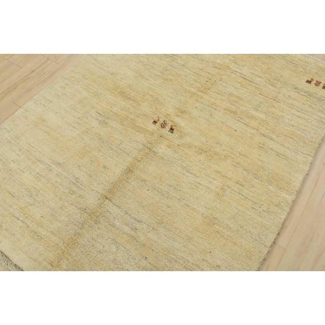 An authentic vintage tribal Gabbeh rug hand-knotted with fine wool and natural dyes. This plush nomadic rug features...