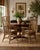 Bring timeless coastal charm to your home with this beautiful pair of vintage organic rattan arm dining chairs. Featuring...