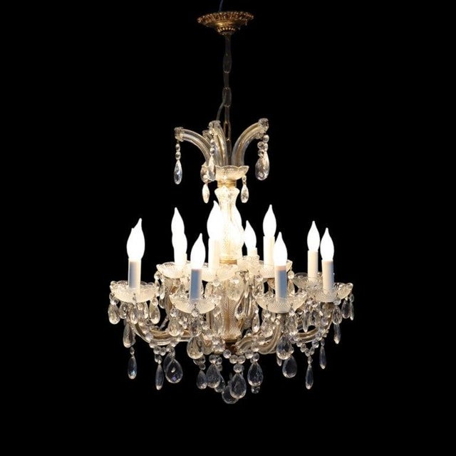 This elegant vintage chandelier, dating to approximately 1940, features a central column and twelve gracefully curved arms...