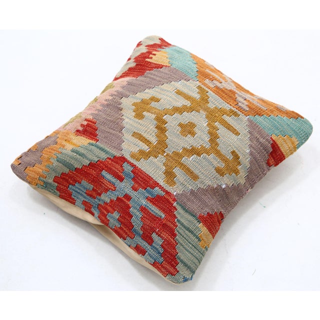 A one-of-a-kind handwoven Afghan wool kilim accent pillow featuring snowflake medallion patchwork. Cut and sewn by hand...
