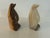 A charming vintage pair of hand-carved penguin figurines executed in translucent banded natural stone, likely alabaster or...
