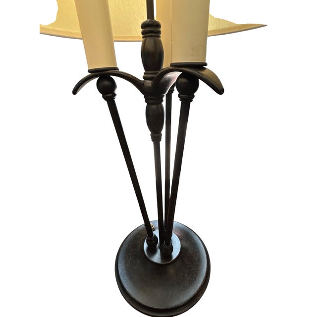 Elegant and understated, this three-light candlestick table lamp offers timeless sophistication with a rich dark bronze...