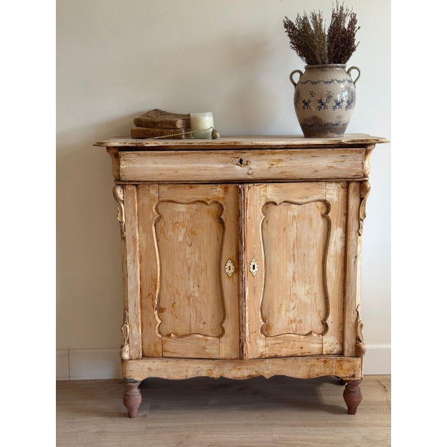 This antique French commode/sideboard is a beautifully worn piece, full of quiet detail and centuries of use. Crafted in...
