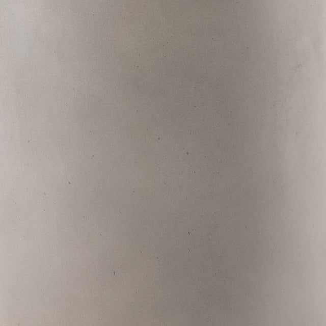 Grey-finished concrete and round shaping make for a naturally sleek planter, indoors or out. Cover or store inside during...