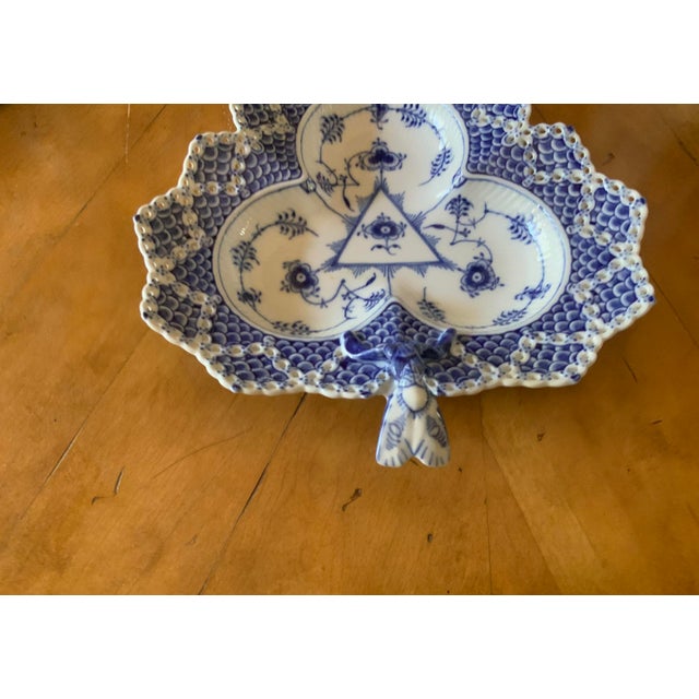 Full lace (Musselmalet Helbolende) design created in 1775. Lace edge is hand pierced before firing. Three section clover...