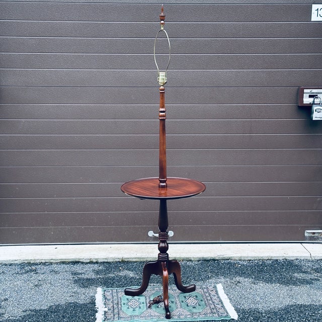 Vintage all solid mahogany wood floor lamp with round tabletop complete with original matching turned mahogany finial. The...