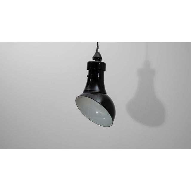This 1930s Czech metal industrial angular pendant lamp embodies the functional aesthetics of early European factory...