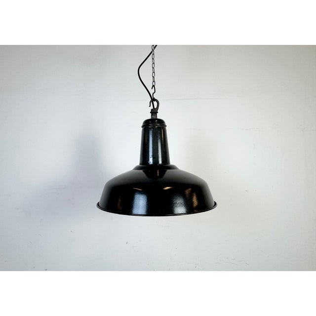 Industrial dark grey ( black ) enamel pendant light made in France during the 1960s. White enamel inside the shade. Metal...
