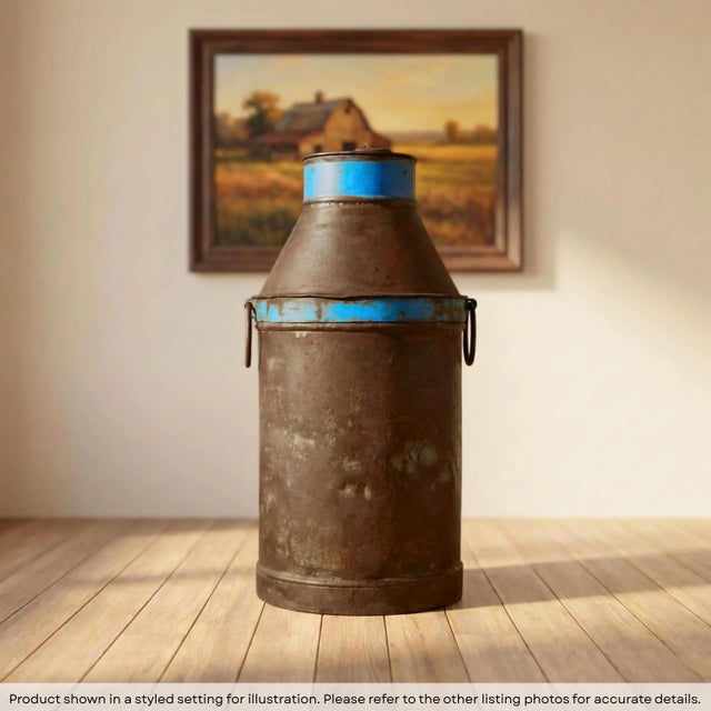 Dimensions: 14" W x 14" D x 29" H This is a vintage milk can or milk churn made from galvanized iron. It wears the...