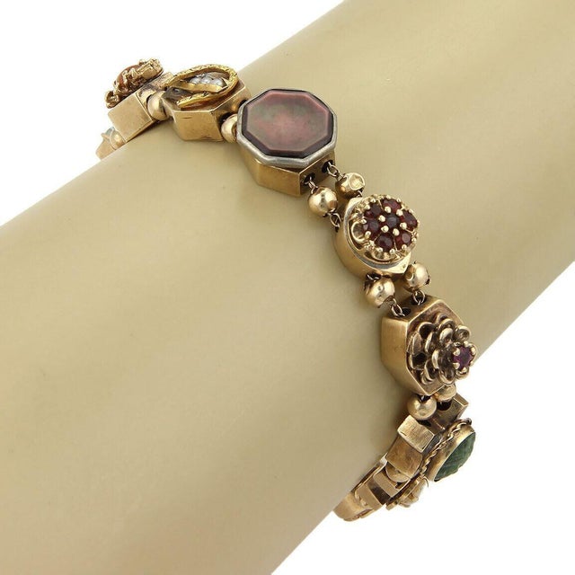 This authentic multicolor gemstone slide charm bracelet is crafted in solid 14k yellow gold and features a vibrant...