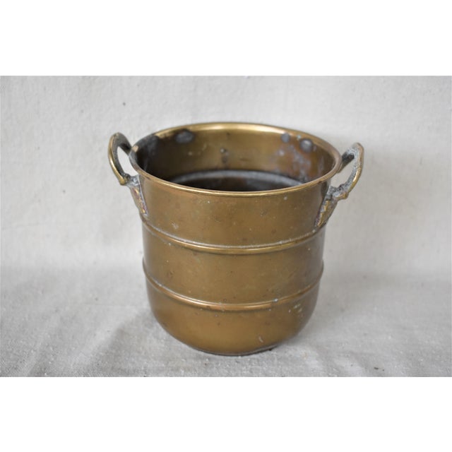 Vintage brass cachepot with leaf handles. This is a pre-owned item so please see all pictures and ask any questions.