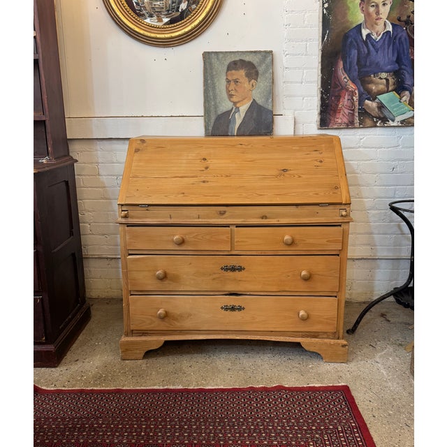 Crafted in England from salvaged European pine, this 1970s drop-front secretary desk offers timeless country style and...