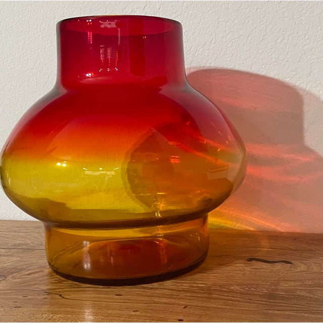 Offering a large blown glass foot vase. Introduce a burst of color to your space with this exquisite blown glass vase....