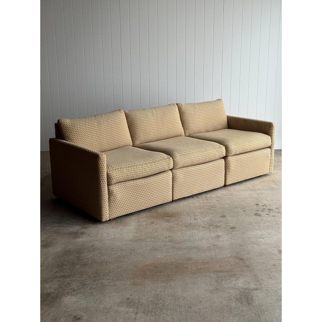 A three-seat vintage sofa with clean, boxy lines and a tailored, tight profile- a hallmark of Pfister’s minimalist,...