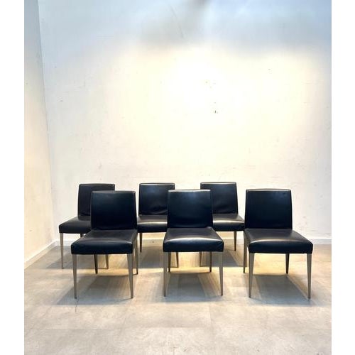 Set of 6 elegant modern dining chairs featuring a clean and timeless design. Upholstered in dark blue leather, these...