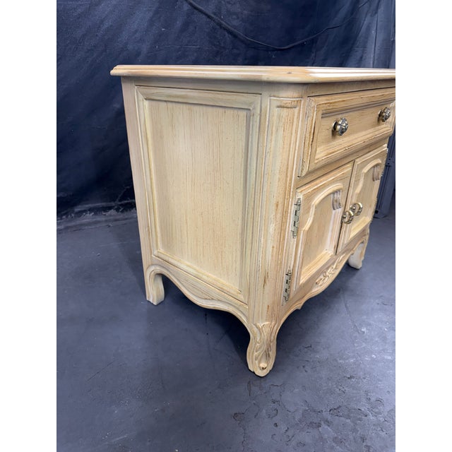 Charming vintage French Provincial nightstand featuring elegant carved details and graceful cabriole legs. This solid wood...