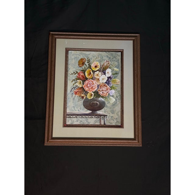 Classic framed floral bouquet artwork featuring a decorative flower arrangement in a dark vase with warm vintage-style...