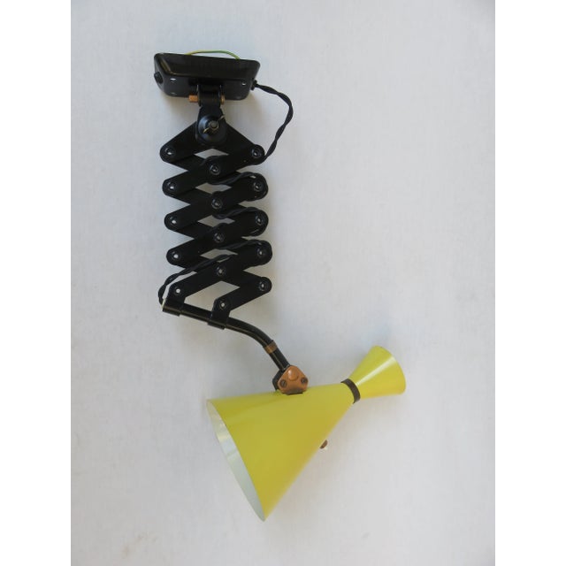 An extremely rare scissor lamp from the 1960s, manufactured by Helo-Leuchten, with an unusual design and typical of the...