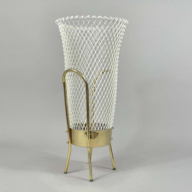 This modernist umbrella stand was designed and manufactured in Italy in the 1950s. The umbrella stand features a tall,...