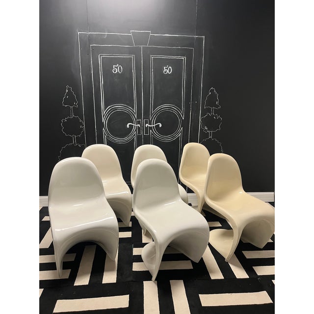 Add a bold touch of modernist flair to your space with this striking set of six Panton-style molded fiberglass chairs....