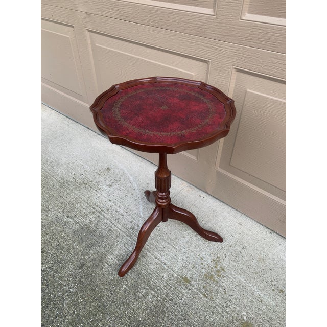 A handsome Georgian-style drinks table crafted in rich mahogany and finished with a beautifully embossed burgundy leather...