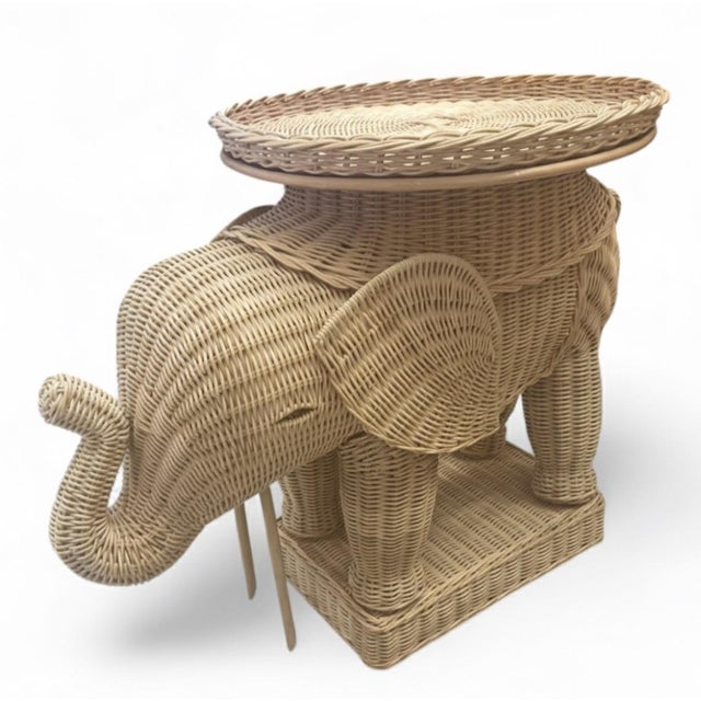 This captivating, single-piece accent table is skillfully crafted from woven rattan in the shape of a majestic elephant....