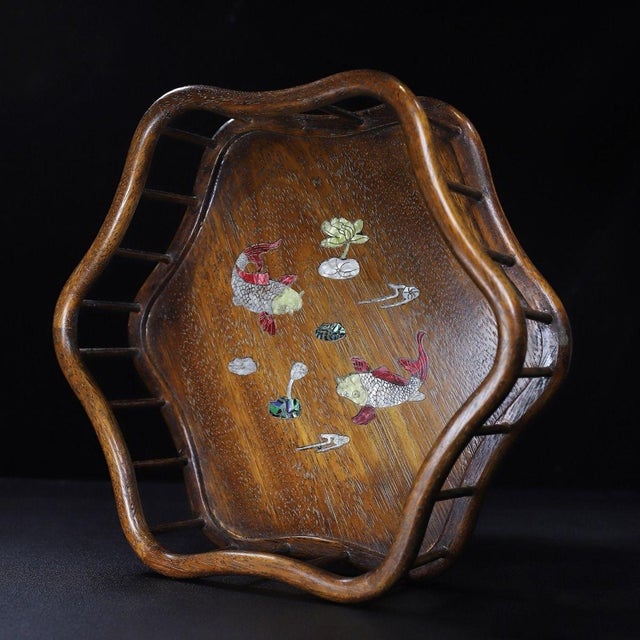 A beautifully crafted Chinese lobed tray or display stand, likely made of Huali (rosewood). The piece features a...