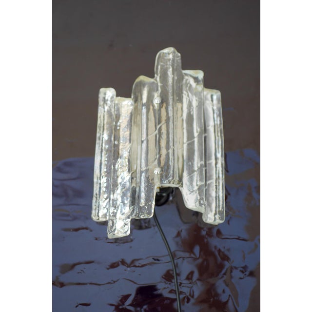 A sculptural glass wall sconce by fischer leuchten, germany, circa 1960s–1970s. this elegant piece features a thick,...