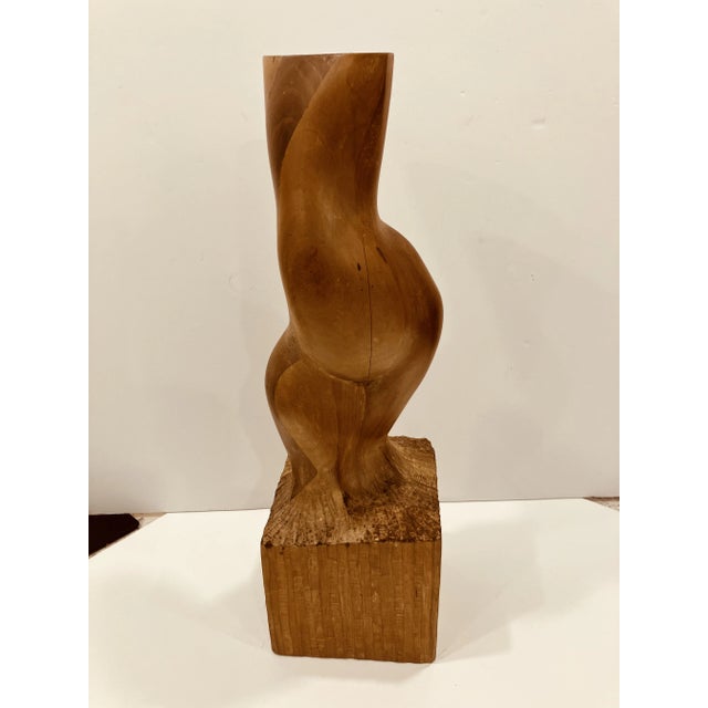 This wood sculpture was created in 1976 The artist signature is hand signed on the base This is an abstraction of a female...