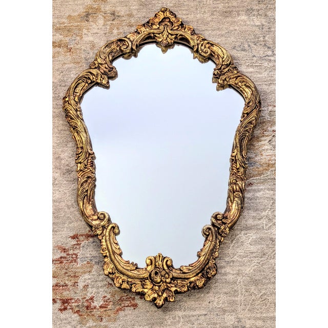 Add dramatic grandeur and timeless romance to your space with this stunning mid-century Hollywood Regency wall mirror....