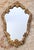 Add dramatic grandeur and timeless romance to your space with this stunning mid-century Hollywood Regency wall mirror....