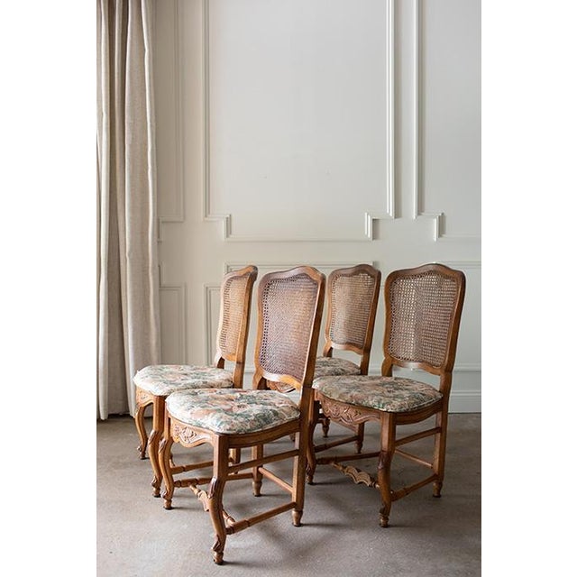 Set of four vintage Henredon dining chairs embodying timeless elegance of French Provincial design. Featuring beautifully...