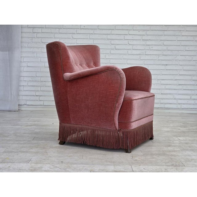 1970s, Danish armchair. Salmon pink furniture velour, oak wood legs, springs in the seat. Original good condition: no...