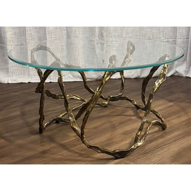 Sculptural Twistwood cocktail table by Studio A (Global Views), featuring an intricate cast iron base finished in antique...