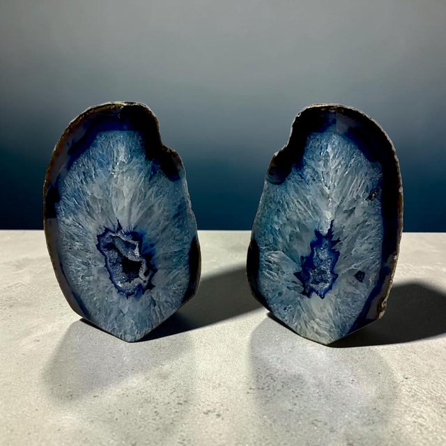 A vintage pair of polished dyed blue agate geode bookends "blue shot eyes" features a vibrant dyed finish and pupil sized...