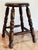 Antique stool featuring dark wood stain with turned wood legs. Seat 175"H. Alternative use as a plant stand. Natural age...