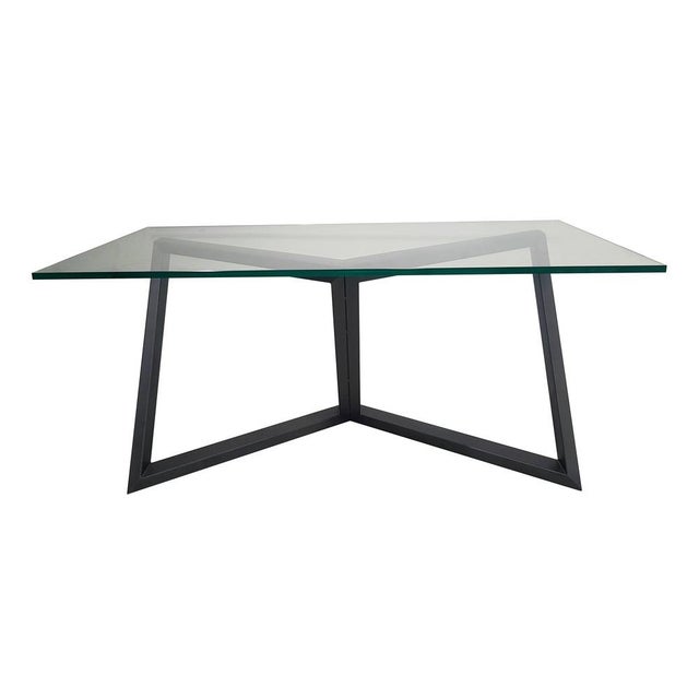 Iron base of the table inspired by the union of four of the six diagonals inside the cube. The top is made of crystal....