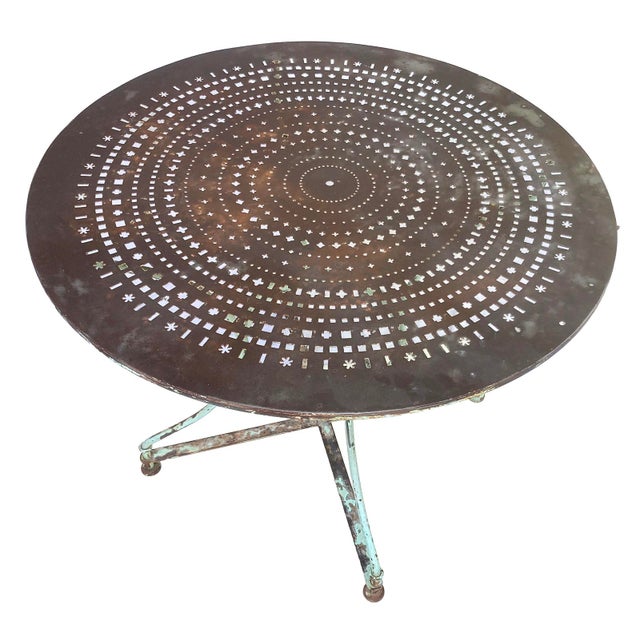 A Fabulous Rustic Antque Metal Garden Table with a pale green Patina'd Base. The top is pierced in a whimsical design and...