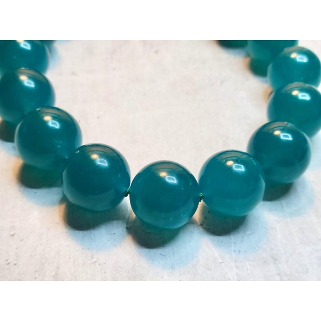 The necklace is 18 inches (45.7 cm) long, and the smooth round beads are 19 mm in size. The beads are a beautiful blue-...