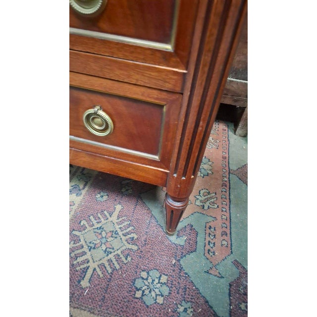 Louis XVI style chest of drawers with a white marble top. This chest has three rows of drawers. Made in the 1950s. Period:...