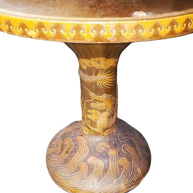Original post-war Chinese glazed art pottery garden pedestal dining table featuring a relief of chinese style dragon along...