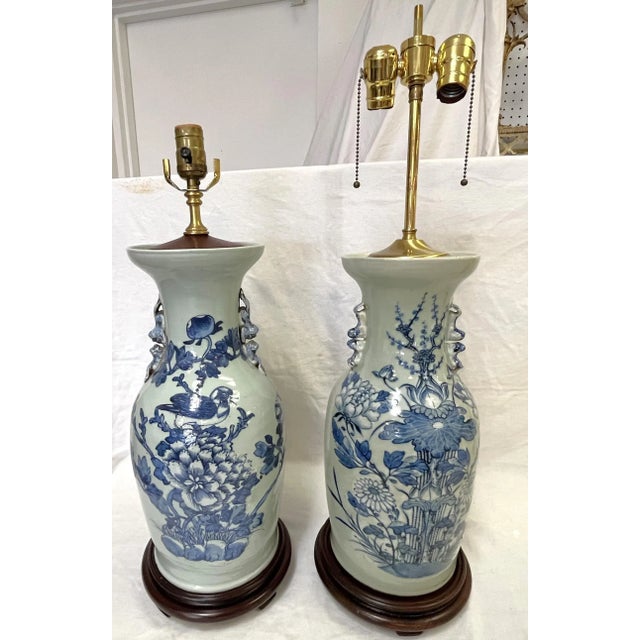 Great vintage Asian Chinoiserie style celadon vases made into lamps. The ceramic vases are hand painted with a navy design...