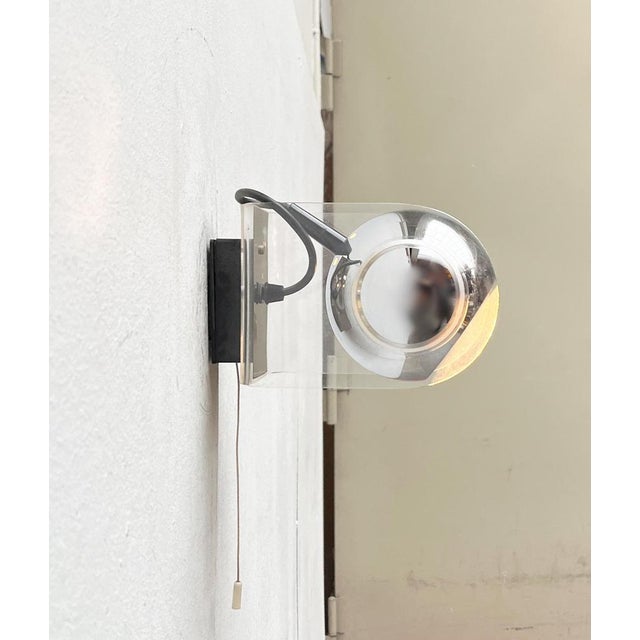 Two Space Age wall lights with a movable ball reflector. The design is based on the 540 model by Gino Sarfatti for...