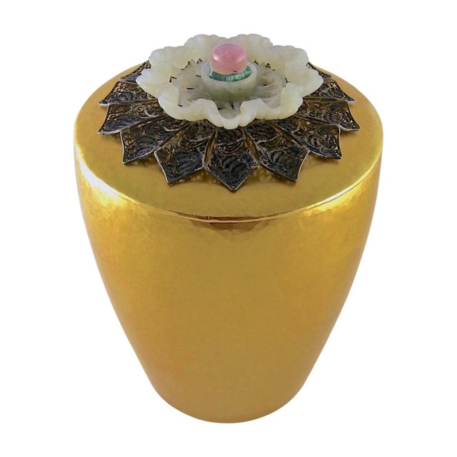 An antique covered box of gilt metal topped with an exquisite finial composed of filigreed metal, rose quartz, variscite,...