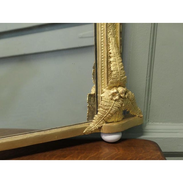 Large Decorative Gilt Arched Over Mantle Mirror This is a beautifully decorative piece the mirror has an arched shape and...
