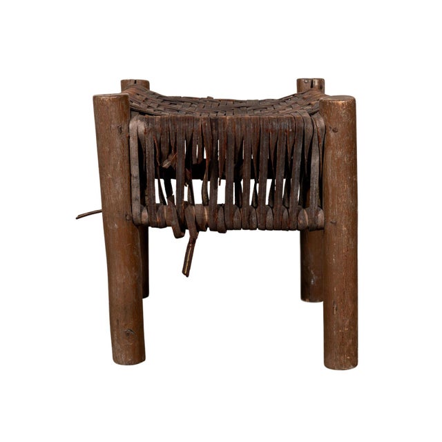 Small rustic stool. Square wooden frame. Handwoven leather seat.