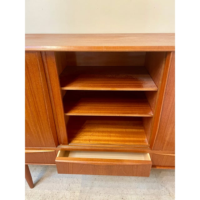 This beautiful Mid-Century Modern credenza has a lot of storage features! This handsome unit has a lot of storage...